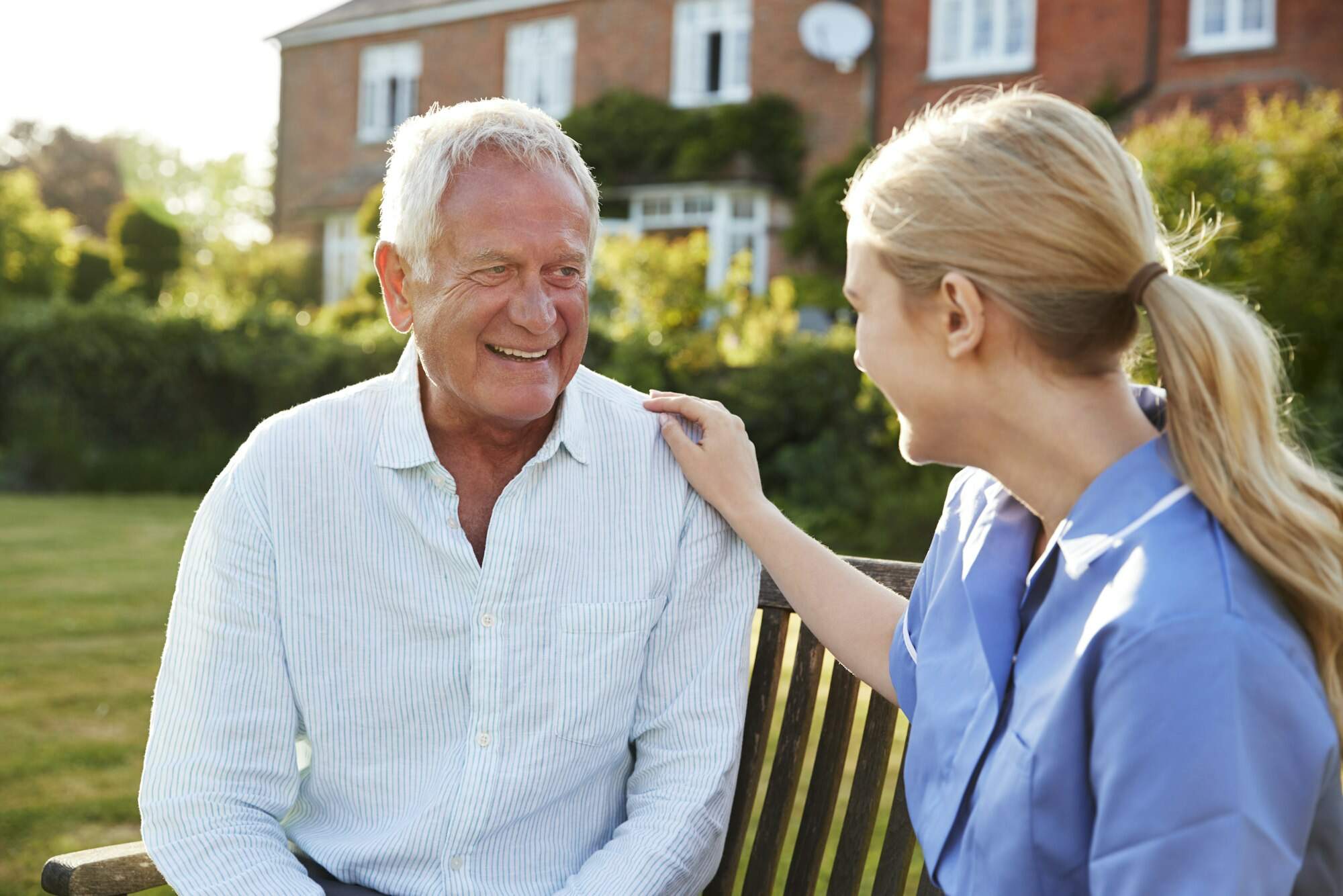 Nurse Talking To Senior Man In Residential Care Home